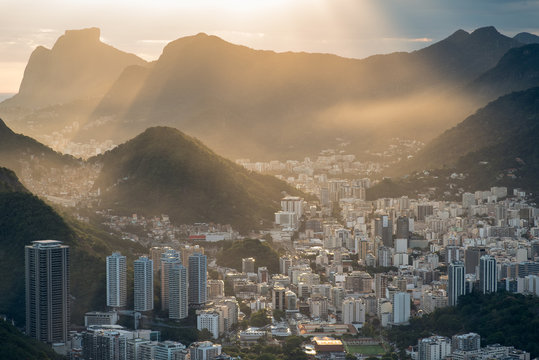 Sun is shining through the clouds on the Rio de Janeiro city, View from the Sugarloaf Mountain