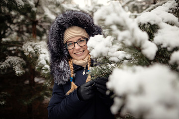 girl in a pine forest in the snow