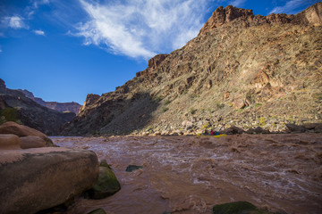 White water rafters in colorado river, rocks in foreground