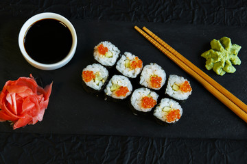  sushi rolls served on stone slate red caviar