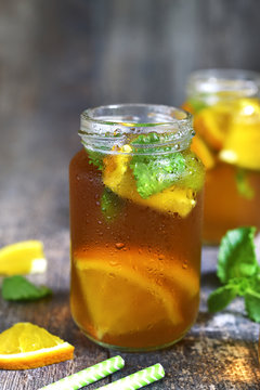 Orange iced tea in a glass jar.