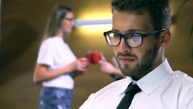 Businessman in glasses works behind a computer closeup