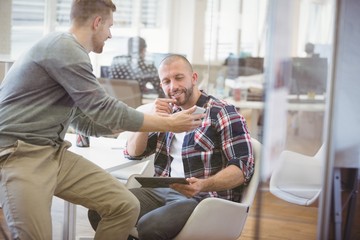 Fototapeta premium Businessman discussing with colleague in office