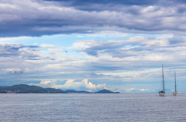 Fototapeta na wymiar Sail boats on sea with cloudy sky