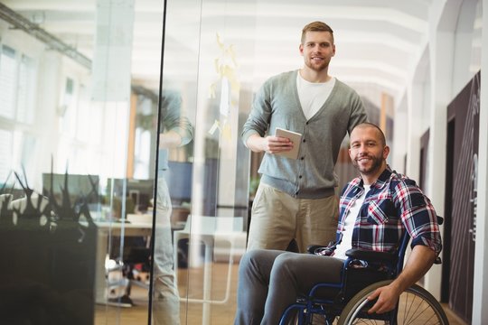 Portrait of handicap businessman with colleague in office