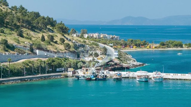 Kusadasi Turkey Turkish Coastal Road Against Blue Aegean Sea Water with Resorts, Boats and a Green Nature Mountain Side at the Popular Vacation Destination