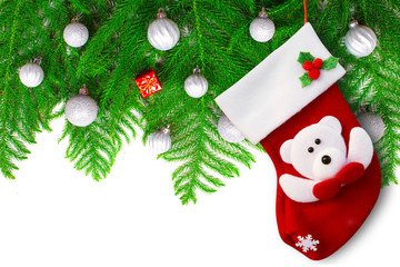 Red christmas sock and christmas tree branch with toys