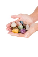 Cropped image of person holding colorful pebbles