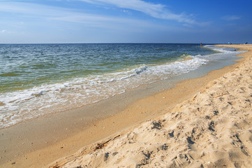 Fototapeta na wymiar Sand beach with surf water background. The summer breeze.