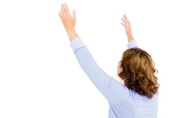 Mature woman with arms raised while praying