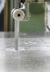 Blade of band saw machine on metal board