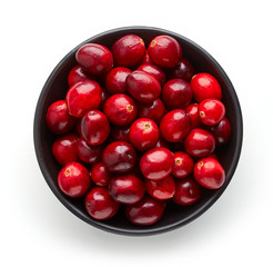 Bowl of cranberries isolated on white, from above