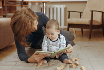 Young mother reading a story to her infant boy
