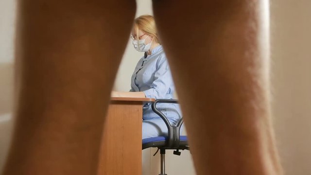 a man is examined by a doctor of the urologist. woman doctor. inspects