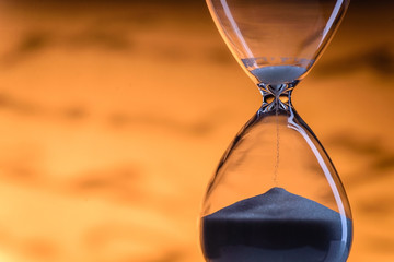 Sand running through an hourglass