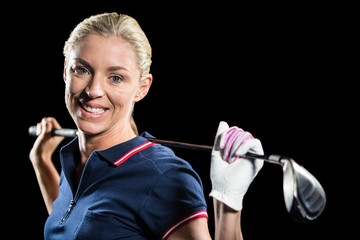 Portrait of golf player holding a golf club and golf ball