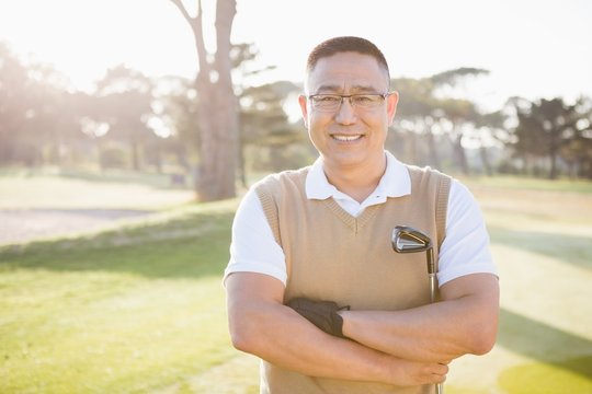 Portrait of golfer posing with his arms crossed