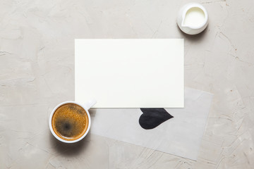 Obraz na płótnie Canvas Mockup. blank paper and cup of coffee on gray concrete background. Top view