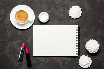 Mockup. blank paper, cup of coffee, white meringue and lipstick on black background.Top view