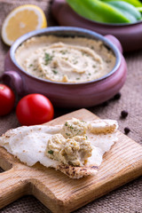 Humus in homemade bowl chapati and vegetable.