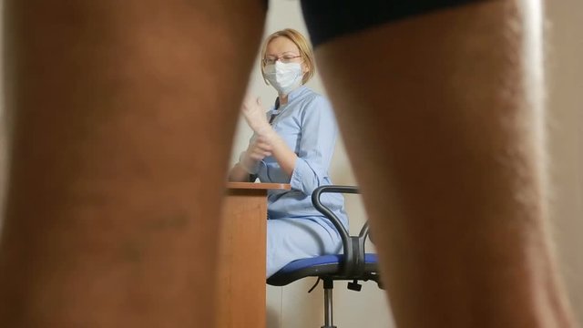 a man is examined by a doctor of the urologist. woman doctor. inspects