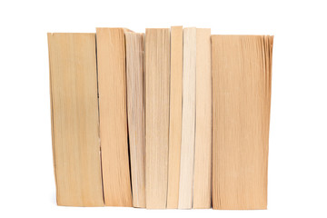 Stack of old paperback books isolated on white background