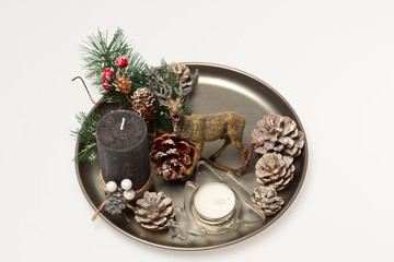 Christmas decoration. Decorating a Christmas tree. A tray with reindeer, candles, and buds.