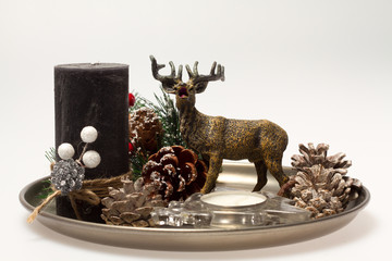 Christmas decoration. Decorating a Christmas tree. A tray with reindeer, candles, and buds.
