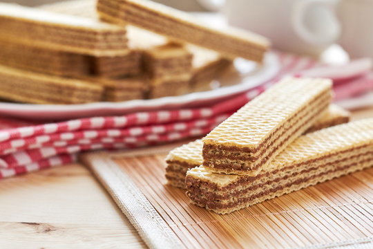 Wafer biscuits with chocolate cream on wooden table