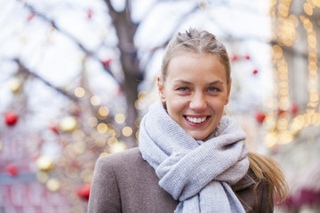 Portrait of a young beautiful woman in gray coat