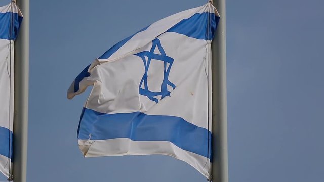 Flags of Israel flapping on a strong wind