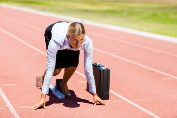 Businesswoman with briefcase ready to run
