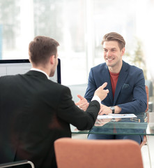 Business partners discussing in meeting hall