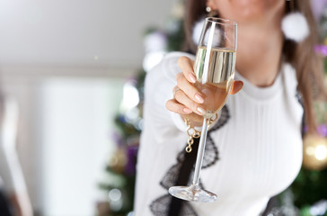 Female hand holding glass of champagne