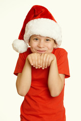 boy child portrait in santa hat, having fun and emotions, winter holiday concept, yellow toned