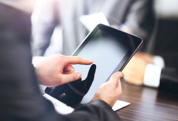 Businessman holding digital tablet at meeting