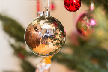 closeup of christmas tree bauble hanging on the branch