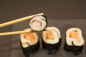 Pieces of sushi on a black stone