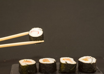 Pieces of sushi on a black stone