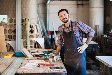 Carpenter working carefully looking at the plans