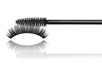 Black mascara brush and false eyelashes close-up isolated on whi