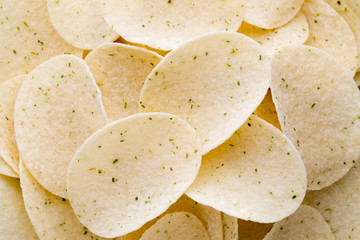 Close up potato chips on wood top view background.