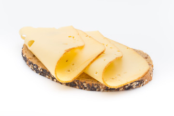 Cheese slices on bread. White background.
