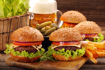 Hamburger with beef meat and fresh vegetables on wooden backgrou