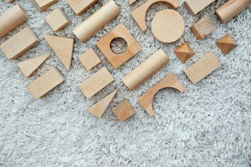 Fototapeta na wymiar Wooden children's building blocks on carpet