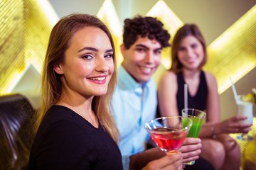 Portrait of joyful friends in nightclub