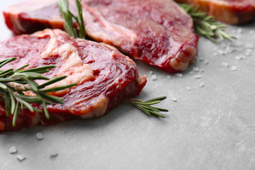 Raw steak with spices on table