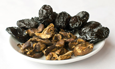 Traditional christmas ingredients for cooking: dried plumps and mushrooms