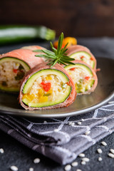 Roasted zucchini stuffed with rice, cheese, pepper and wrapped in Prosciutto slices