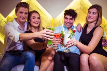 Friends toasting cocktail in nightclub